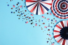 4th Of July American Independence Day, Celebration, Patriotism And Holidays Party Concept From Paper Fans And Confetti Usa Flag Colors Top View On Blue Background. Copy Space 