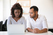 © Mangostar - Corporate trainer explaining company project details to newcomer. Business man and woman in casual sitting at workplace, using laptop and talking. Internship concept