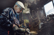 © Parilov - Senior elderly male turner handles metal on machine. Concept pension worker industrial, workplace