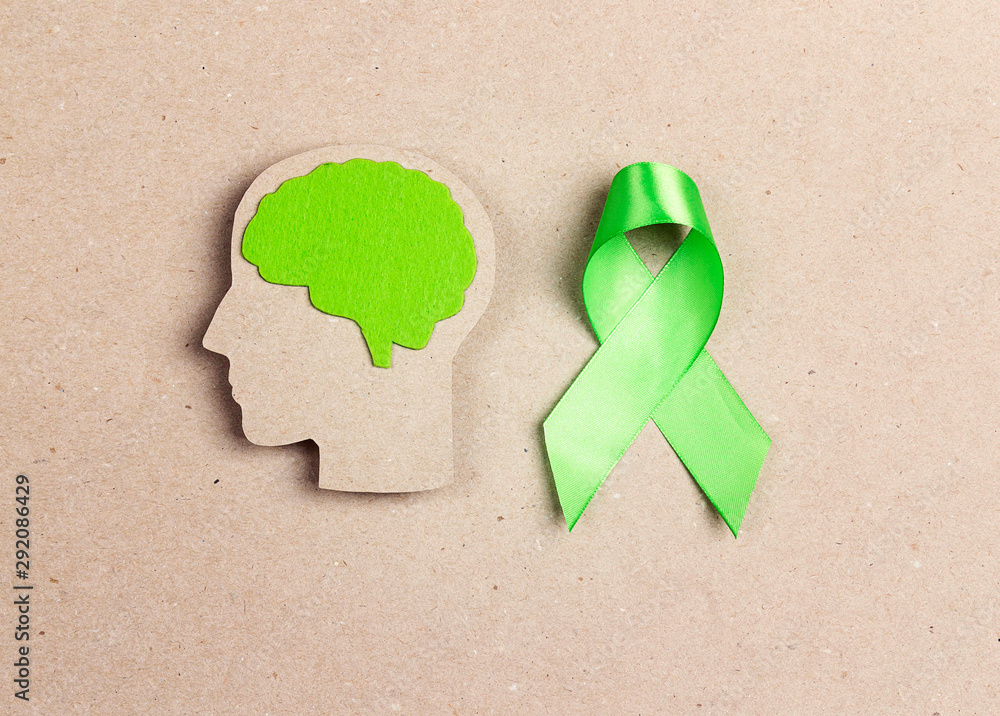 World mental health day concept. Green awareness ribbon and brain ...
