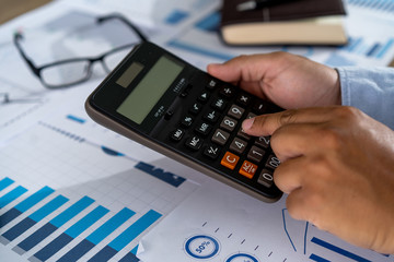 Wall Mural - businessman working using a calculator finance accounting concept achievement to balance man assistant accounting