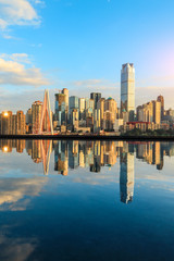 Chongqing skyline and modern urban skyscrapers with water reflection at sunset,China.