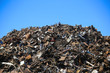 © shubas - Mountain of scrap metal, against a blue background. Scrap heap