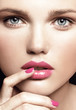 close-up portrait of attractive young model with bright make-up and manicure