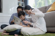 © FrameAngel - Asian family father, mother and son playing laptop computer together in living room, happy family concept
