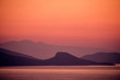 sunset with mountains on sea
