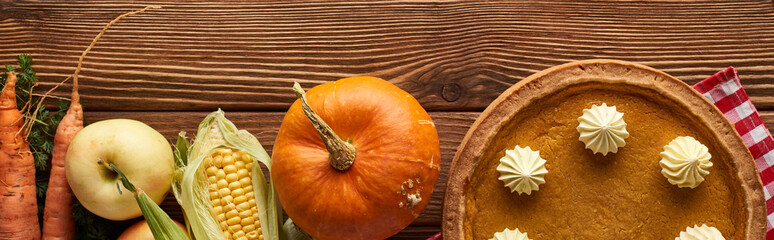 Wall Mural - panoramic shot of checkered tablecloth with autumn fruit, vegetables and pumpkin pie on wooden surface