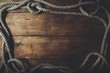 © ronstik - rope frame on old brown wooden plank background