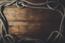 Rope Frame On Old Brown Wooden Plank Background