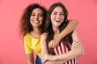 © Drobot Dean - Image of cheerful multinational girls hugging and smiling together at camera