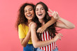 © Drobot Dean - Image of happy multinational girls hugging and showing peace sign