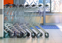 Shopping Carts In The Supermarket Are At The Entrance To The Store. Side View