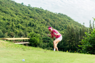 Asian woman golfer action to win after long putting golf ball on the green golf.  Healthy Concept