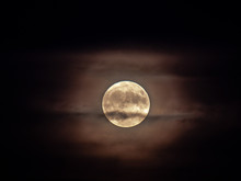 A Closeup View Of The Micro Harvest Full Moon With Partial Cloud Cover And Halo On Friday The 13th As Seen In Chicago On A Black Night Sky Backdrop Making For A Creepy, Spooky Or Scary Scene.