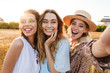 Photo of happy caucasian women taking selfie photo and laughing