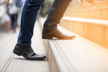 image of a man walking up the stairs to achieve the goal