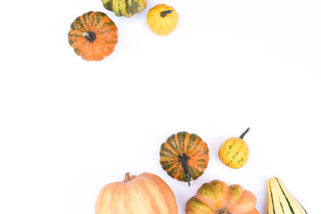 Wall Mural - Autumn flat lay on an isolated white background made of pumpkins.