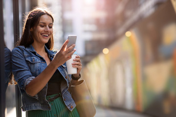 Young woman with smartphone in an urban city area