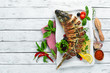 Baked stuffed fish carp with vegetables. Restaurant dishes. Top view. Free space for your text.