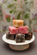 © lloyd - Colourful Australian dessert Lamingtons stacked and served on a cake stand