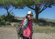 © OlgaVELES - Happy girl tourist goes on the trail turns around and holds out his hand, follow me