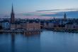 A colorful sunrise over Stockholm with the lights reflecting on the calm water of the sea - 4