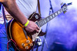 © bukhta79 - Stage lights.Playing guitar and concert concept.Live music background.Rock concert.Music festival.Instrument on stage and band,bass guitarist.