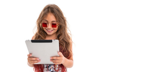 Panorama of smiling girl in square red sunglasses reading something on tablet screen isolated