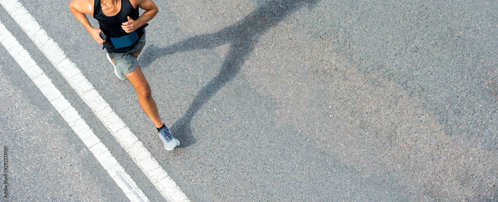 Close up of runner feet. Fitness background, close up of runner feet on the road. - obrazy, fototapety, plakaty 