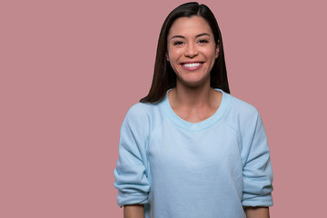 Casual beautiful young asian american isolated portrait on pink background, genuine sincere smile with nice straight white teeth