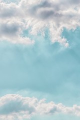 Wall Mural - Delicate light rays through clouds on a pastel aqua color sky background