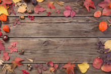 Autumn Leaves On Darrk Old Wooden Background