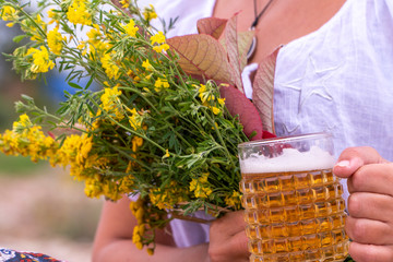 A young woman in a white shirt with beer at Oktoberfest is a folklore festival held annually in Munich, the largest folk festival in the world.