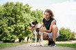 © Pixel-Shot - Sporty young man with cute dog in park