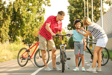 Sticker - Parents teaching their son to ride bicycle outdoors