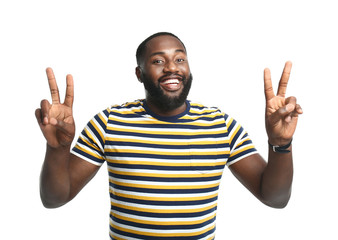 Sticker - Handsome African-American man showing victory gesture on white background