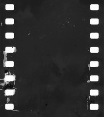 original filmstrip with empty dusty frames or cells and nice texture on the border, fluffs on film material, real film grain