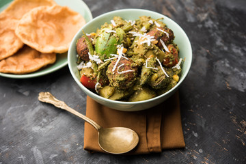 Wall Mural - Undhiyu is a Gujarati mixed vegetable dish, specialty of Surat, India. Served in a bowl with or without poori