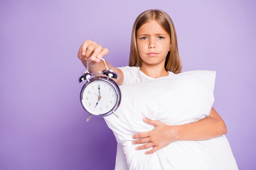 Sticker - Oh 7 oclock again. Portrait of upset disappointed beautiful kid hug hold hand pillow show clock early time dont want awake and go study wear white t-shirt isolated over purple violet color background