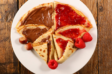 Wall Mural - delicious crepe with chocolate and raspberry jam