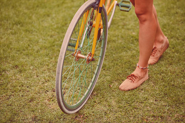 Wall Mural - Pretty woman standing with old bicycle outdoors.