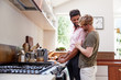 © Monkey Business - Male Gay Couple At Home In Kitchen Making Breakfast Together