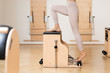 © LUMINA IMAGES - Unrecognisable woman doing leg exercise on pilates chair.