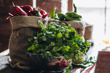 Parsley, red and green hot peppers in linen bags