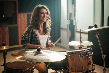 Wall Mural - Woman playing drums during music band rehearsal