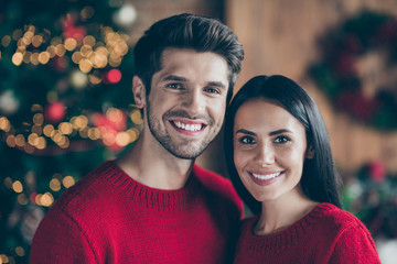 Poster - Close up photo of charming romantic couple with brunette hair enjoying christmas night x-mas holidays wearing red pullover in room with illumination newyear lights indoors