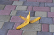 © OlegD - Banana peel was left on the pavement. The danger may slip. If anyone walks on it. Be careful of slippery. Closeup, outdoors