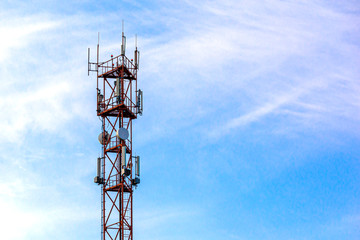 Telecommunication tower against the blue sky with clouds. LTE, GSM, 2G, 3G, 4G, 5G cell tower. Telecommunication tower against the sky. Copy space.