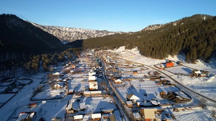 Wall Mural - A beautiful aerial shot of winter village, mountain winter resort in Altai