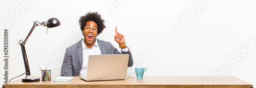 Fotografía young black businessman feeling like a happy and excited genius after realizing